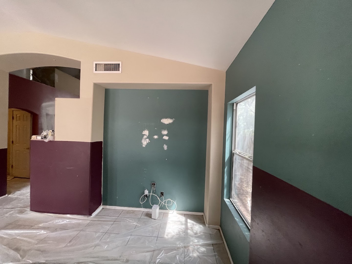 Interior room during a Santana Desert Painting project with protected floors and patched walls